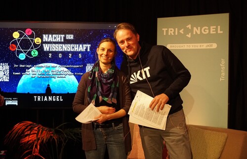 Ein Mann und eine Frau vor der Powerpoint Pr&auml;sentation