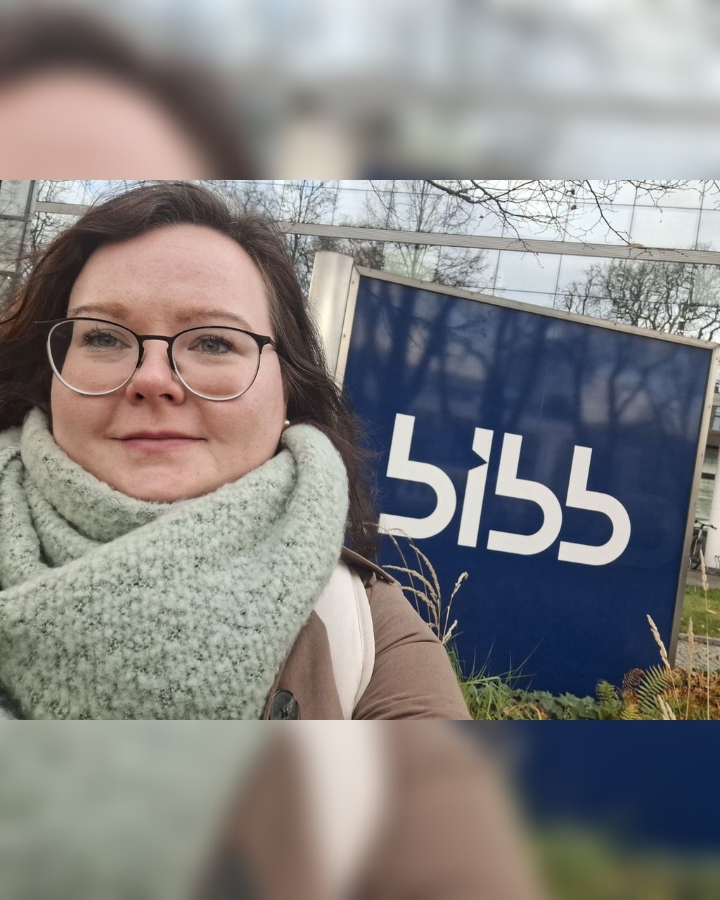 Frau vor dem Schild BIBB